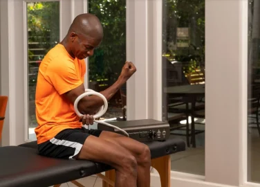 Man uses TeslaFit PEMF Butterfly Coil on his elbow