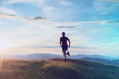 Man running through hills with mountains in the back